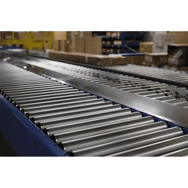 Medium-duty galvanized gravity roller conveyor straight section in industrial warehouse setting for material handling applications
