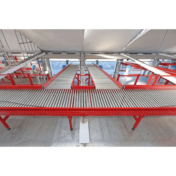 Medium-duty galvanized gravity roller conveyor straight section installed in warehouse environment for material handling operations