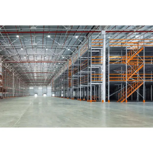 Structural steel mezzanine system in warehouse environment for storage expansion and industrial workspace optimization