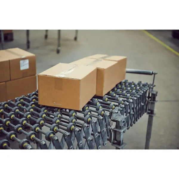Flexible gravity conveyor lifestyle image with brown box portable roller conveyor material handling system
