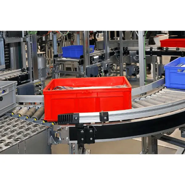 Galvanized gravity roller conveyor curved section lifestyle view right angle industrial warehouse material handling system
