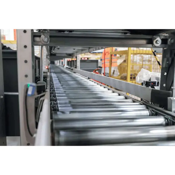 Light-duty galvanized gravity roller conveyor straight section in warehouse lifestyle setting for material handling operations
